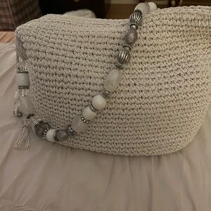 Summer straw bag with silver and gray beads for handle.